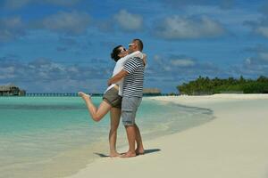 happy young couple have fun on beach photo