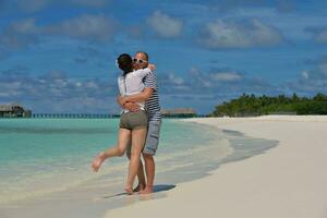 happy young couple have fun on beach photo