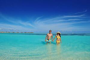 happy young  couple enjoying summer on beach photo