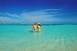 happy young  couple enjoying summer on beach photo