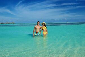 happy young  couple enjoying summer on beach photo