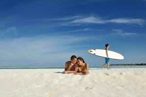 asian couple enjoying summer on beach photo