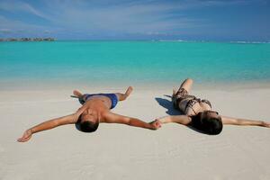 happy young  couple enjoying summer on beach photo