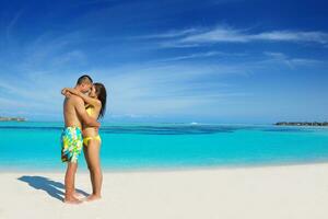 happy young  couple enjoying summer on beach photo