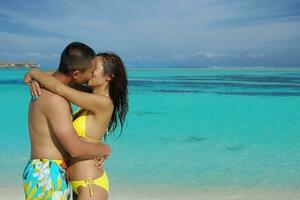 asian couple enjoying summer on beach photo