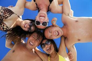 group of happy young people have fun on bach photo