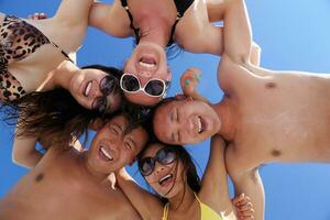 group of happy young people have fun on bach photo