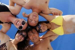 group of happy young people have fun on bach photo