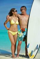 happy young  couple enjoying summer on beach photo