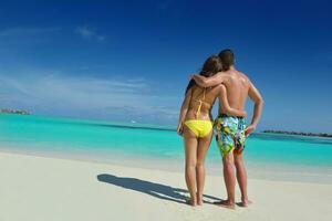 happy young  couple enjoying summer on beach photo