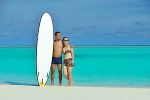 happy young  couple enjoying summer on beach photo