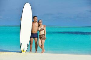 happy young  couple enjoying summer on beach photo