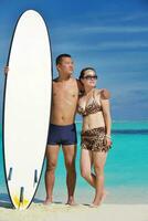 happy young  couple enjoying summer on beach photo