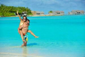 happy young  couple enjoying summer on beach photo