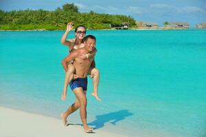 happy young  couple enjoying summer on beach photo