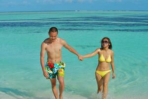 asian couple enjoying summer on beach photo