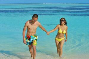 asian couple enjoying summer on beach photo