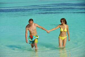 asian couple enjoying summer on beach photo