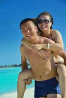 happy young  couple enjoying summer on beach photo