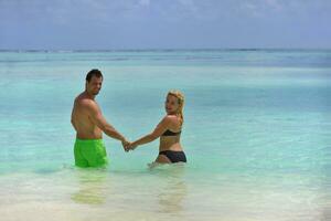 happy young  couple at summer vacation have fun and relax at beach photo