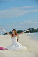 asian bride on beach photo