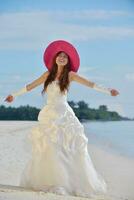 asian bride on beach photo