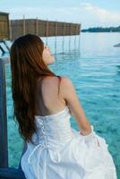 asian bride on beach photo