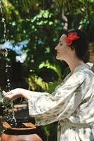 splashing fresh water on woman hands photo