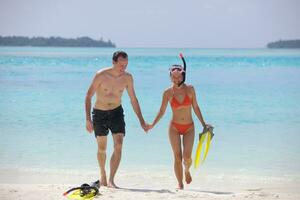 happy young couple have fun on beach photo