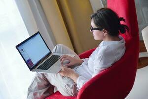 woman using a laptop computer at home photo