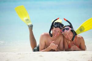 happy young couple have fun on beach photo