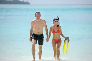 happy young couple have fun on beach photo