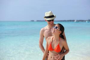 happy young couple have fun on beach photo