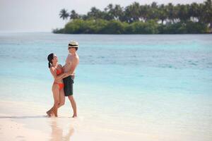 happy young couple have fun on beach photo