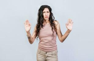 Scared woman with raised hands isolated. Young woman with scared face with raised hands, Scared and horrified girl with raised palms photo