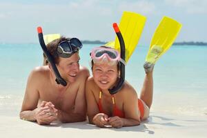 happy young couple have fun on beach photo