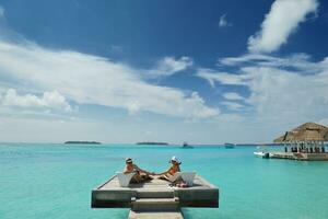 happy young couple have fun on beach photo