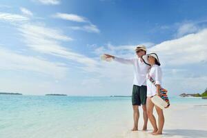 happy young couple have fun on beach photo