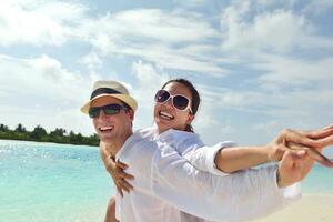 happy young couple have fun on beach photo