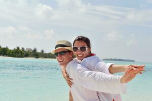 happy young couple have fun on beach photo