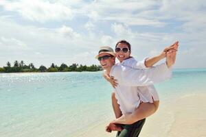 happy young couple have fun on beach photo