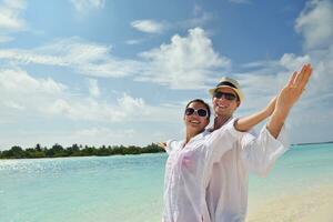 happy young couple have fun on beach photo