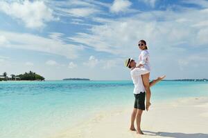 happy young couple have fun on beach photo