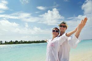 happy young couple have fun on beach photo