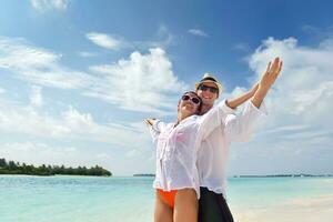 happy young couple have fun on beach photo