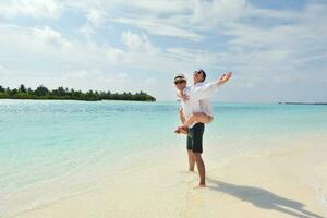 feliz pareja joven divertirse en la playa foto