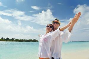 happy young couple have fun on beach photo