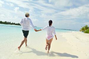 happy young couple have fun on beach photo