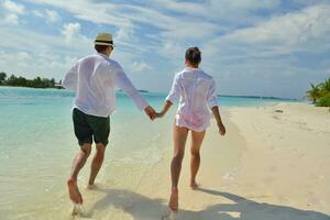 happy young couple have fun on beach photo