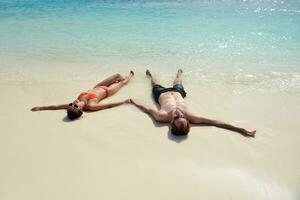 happy young couple have fun on beach photo